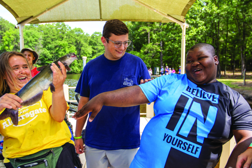 Zay-lon catches a fish at summer camp.